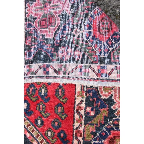 815 - A vintage hand woven Persian Afshar rug, the twin central lozenge medallions upon a blue field withi... 