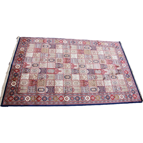 817 - A rich blue ground full pile Kashmir carpet, with an all over panel design, 302cm x 192cm