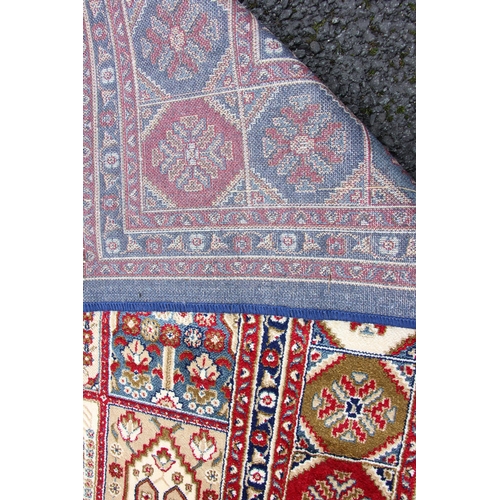 817 - A rich blue ground full pile Kashmir carpet, with an all over panel design, 302cm x 192cm