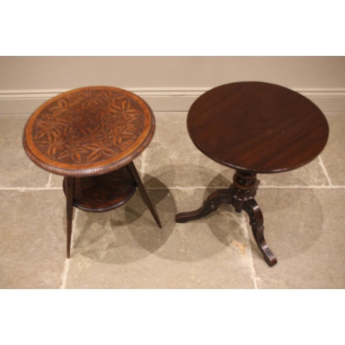 946 - A circular carved oak occasional table, early 20th century, the top carved with bamboo foliate detai... 