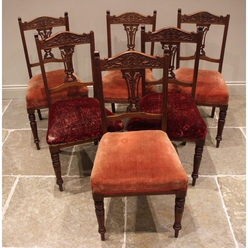 951 - A set of six late Victorian walnut dining chairs, each with a carved and pierced splat back, stuff-o... 