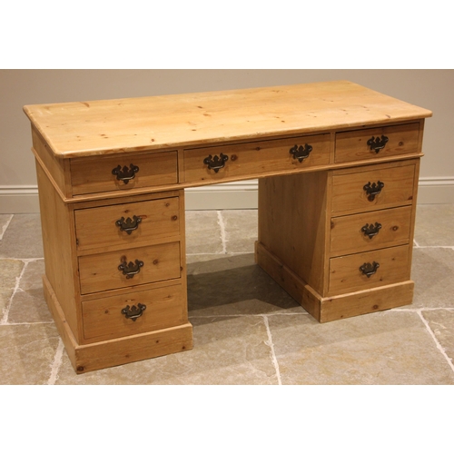 963 - A Victorian style pine desk/dressing table, the top with three frieze drawers upon twin pedestals ea... 