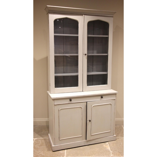 965 - A Victorian style painted pine glazed housekeepers cupboard, the moulded cornice over a pair of glaz... 