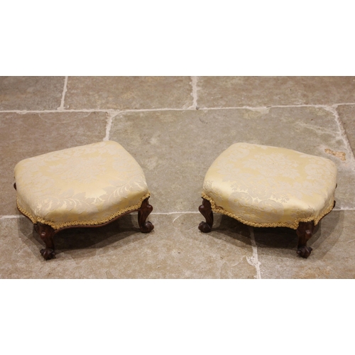 968 - A pair of Victorian walnut footstools, of serpentine stuff-over form, raised upon French squat cabri... 