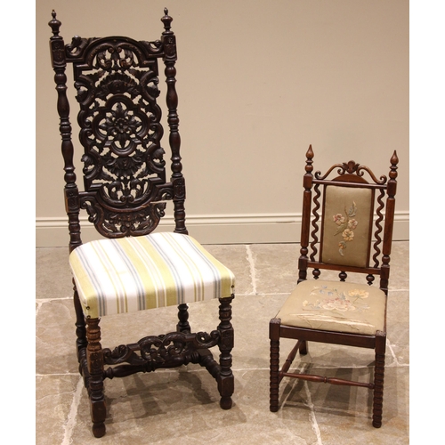 970 - A Carolean revival carved oak hall chair, 19th century, the carved openwork back rest over a re-upho... 