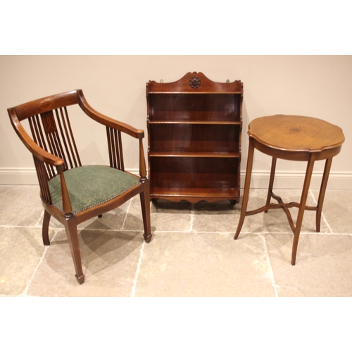 997 - An Edwardian mahogany and inlaid library chair, the down swept arms over a padded serpentine seat, t... 