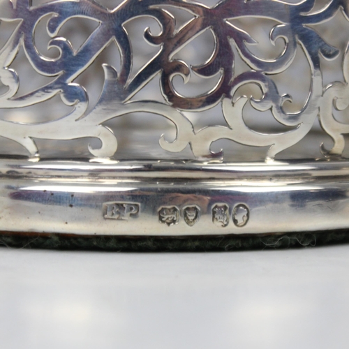 107 - A Victorian silver bottle coaster, 'BP' London 1843, the cast rim above a pierced gallery and engrav... 