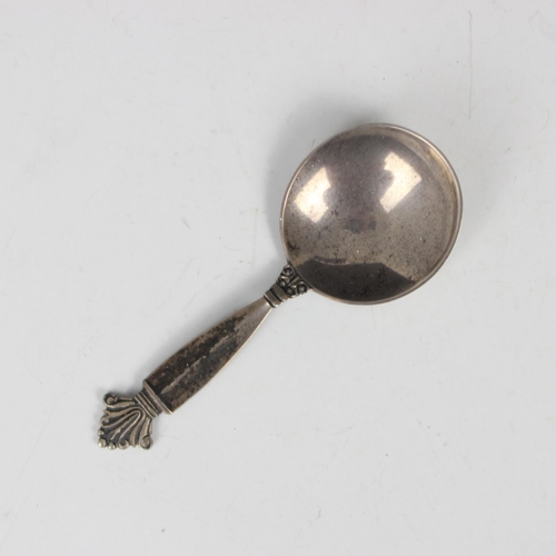 11 - A Georg Jensen silver caddy spoon, with shaped terminal leading to plain polished bowl, stamped 'Geo... 