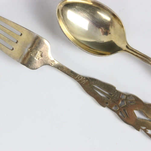 112 - A pair of A. Michelsen Danish Christmas spoons, 1941, the silver gilt soon and fork with mistletoe d... 