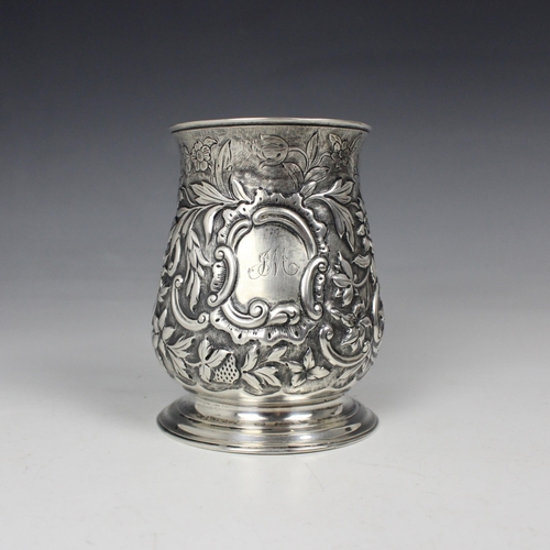 22 - A George II silver mug, London 1747, the bulbous body with later embossed decoration of strawberries... 