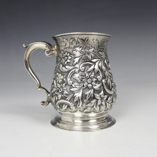 22 - A George II silver mug, London 1747, the bulbous body with later embossed decoration of strawberries... 