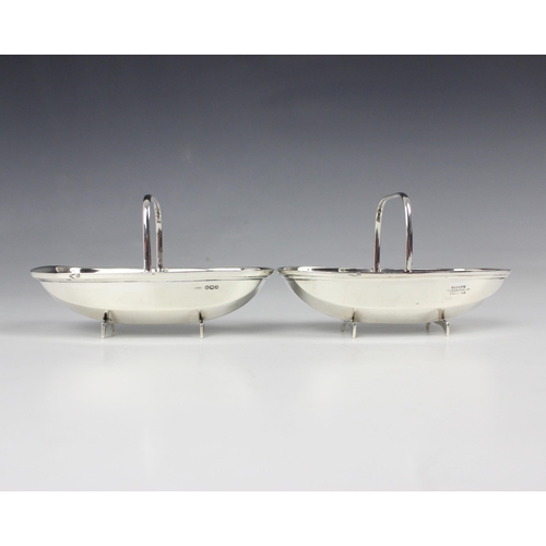 52 - A near pair of George V silver sweetmeat baskets, James Dixon and Sons, Sheffield 1910/1930, designe... 