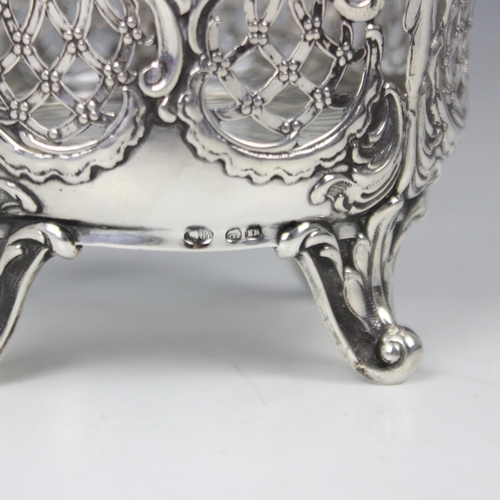 59 - An early 20th century Russian silver sugar basket, WH, Kostroma, the cast shaped swing handle above ... 