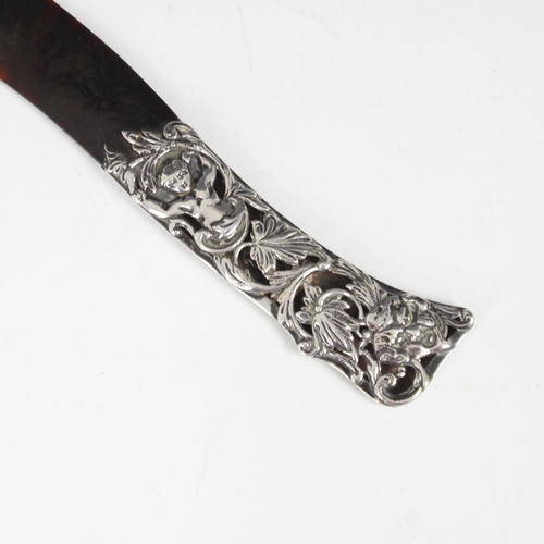 66 - A Victorian silver mounted 'tortoiseshell' paper knife, London 1889, designed as a scimitar with sil... 