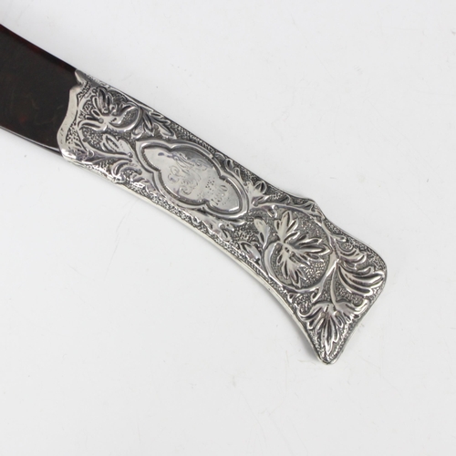 66 - A Victorian silver mounted 'tortoiseshell' paper knife, London 1889, designed as a scimitar with sil... 