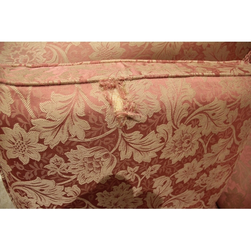 1021 - A Knole type three piece lounge suite, late 20th century, in pink floral fabric, comprising a drop-e... 