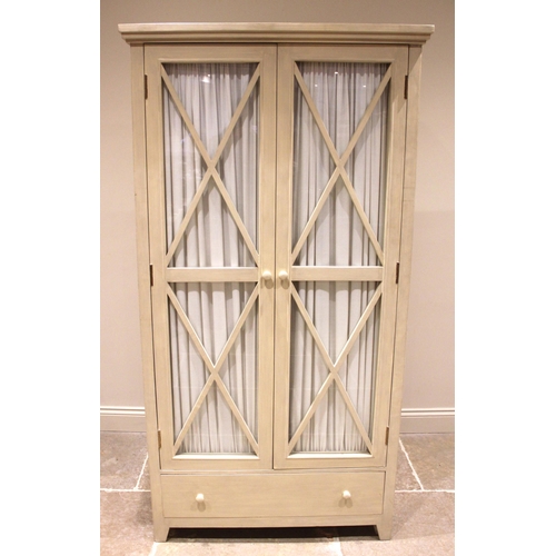 1023 - An Oka Alford armoire/wardrobe, the lattice beaded glazed doors with pleated curtains to the interio... 