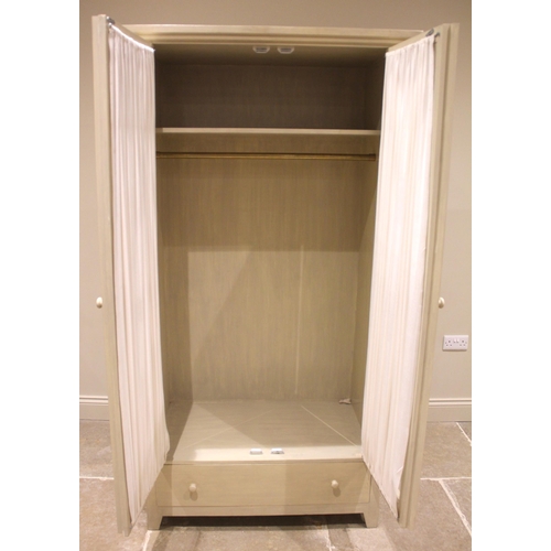 1023 - An Oka Alford armoire/wardrobe, the lattice beaded glazed doors with pleated curtains to the interio... 