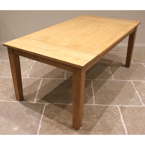 1028 - A contemporary light oak dining table, the plank top upon tapering legs of square section, 76cm H x ... 