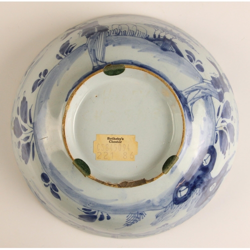 602 - An 18th century Delft tin-glazed earthenware bowl, of circular form and decorated in the Chinese man... 