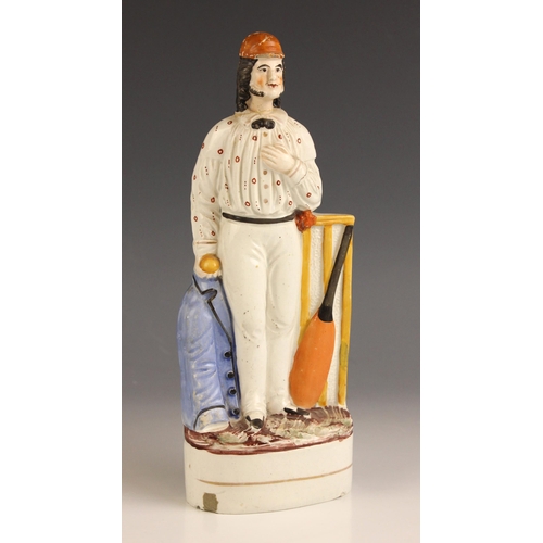 614 - A Staffordshire pottery flatback figure of a cricketer, 19th century, 26cm high (at fault)