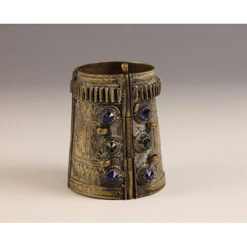 638 - A North African brass 'Kuchi' cuff, Berber Tribe, 20th century, of hinged construction with chased d... 