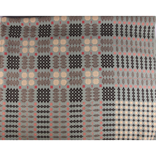 647 - A woollen Welsh blanket, in sage green, pink and oatmeal colourways, with a traditional geometric an... 