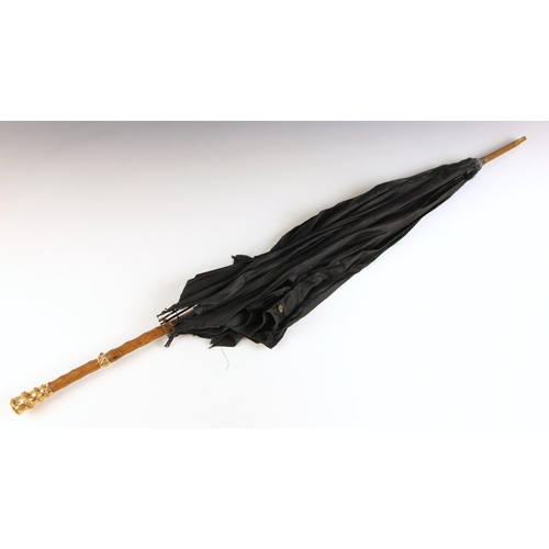 671 - A 19th century gold plated parasol, the florally decorated handle stamped '18ct GP' with black silk ... 