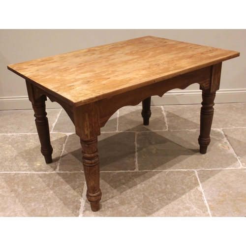 975 - A Victorian pitch pine kitchen/scullery table, the rectangular plank top above a wavy apron, upon ri... 