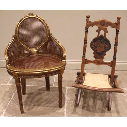 976 - A late 19th century inlaid folding campaign chair, the ogee shaped splat back inlaid with a vase of ... 