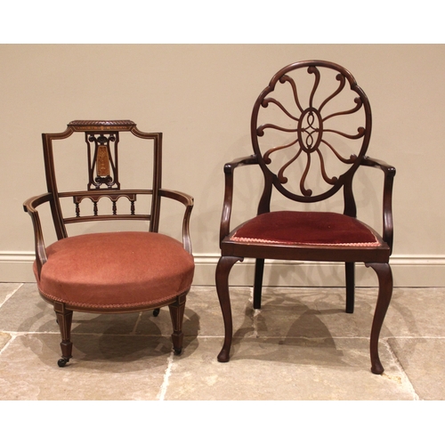 999 - An Edwardian mahogany elbow chair, the oval back rest centred with twelve radiating curvilinear arms... 