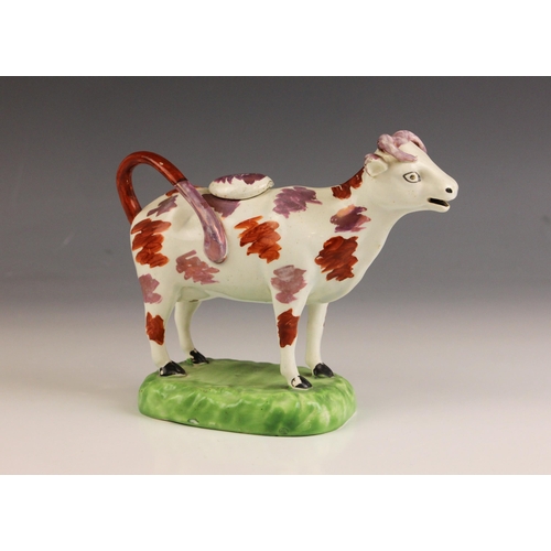 607 - An English pottery cow creamer, Yorkshire, 19th century, with lustre decoration, modelled standing o... 