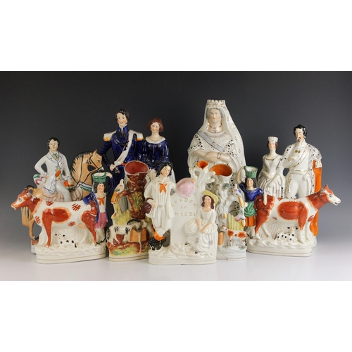 616 - A collection of Staffordshire flatback figures, 19th century, to include The Queen of England, 42cm ... 