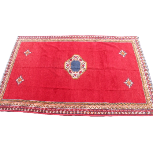 808 - A hand woven full wool pile Persian Qashqai nomadic rug, the plain red field with a central medallio... 