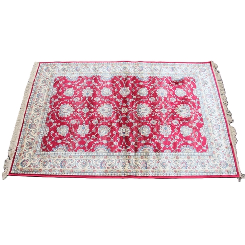 811 - A red ground full pile Kashmir rug, with an all over Ziegler floral design, 170cm x 120cm