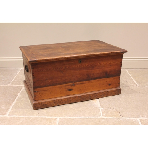 966 - A Victorian pine blanket chest/trunk, applied with iron swing handles, upon a moulded plinth base, 4... 