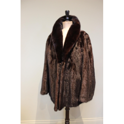 654 - A dark brown mink fur coat, by Chris Courtenay Williams, half length, 71cm long