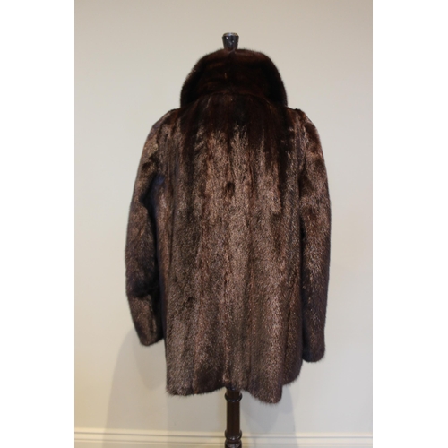 654 - A dark brown mink fur coat, by Chris Courtenay Williams, half length, 71cm long