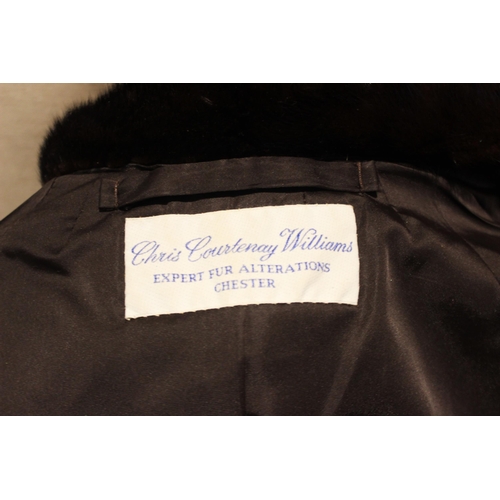 654 - A dark brown mink fur coat, by Chris Courtenay Williams, half length, 71cm long