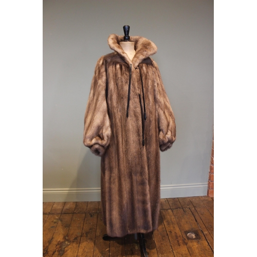 662 - A mink full length fur coat retailed by D.H. Evans of Oxford St, with billowy sleeves and leather ti... 