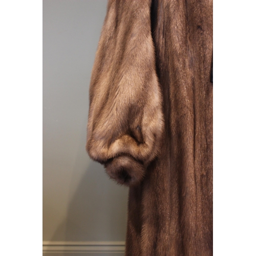 662 - A mink full length fur coat retailed by D.H. Evans of Oxford St, with billowy sleeves and leather ti... 