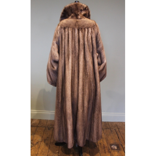 662 - A mink full length fur coat retailed by D.H. Evans of Oxford St, with billowy sleeves and leather ti... 