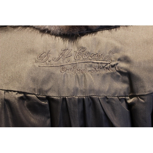 662 - A mink full length fur coat retailed by D.H. Evans of Oxford St, with billowy sleeves and leather ti... 