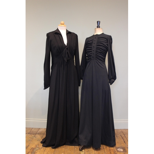 665 - An Ossie Clark black crepe full length evening / dinner dress, with button and bow detail to the fro... 