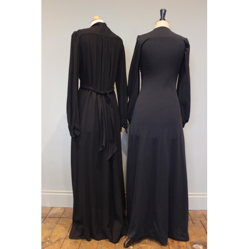 665 - An Ossie Clark black crepe full length evening / dinner dress, with button and bow detail to the fro... 