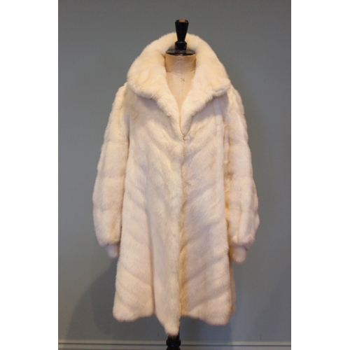 666 - A three quarter length white mink coat by J. Hoffman of Manchester, worked in a chevron design to th... 