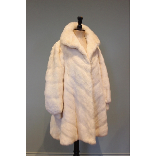 666 - A three quarter length white mink coat by J. Hoffman of Manchester, worked in a chevron design to th... 