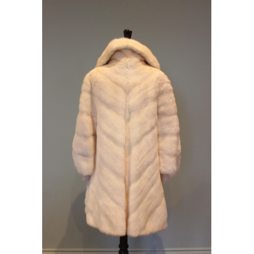 666 - A three quarter length white mink coat by J. Hoffman of Manchester, worked in a chevron design to th... 