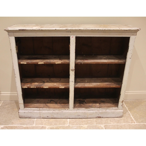 973 - A Victorian painted pine cupboard, the pair of panelled doors opening to twin compartments, each wit... 