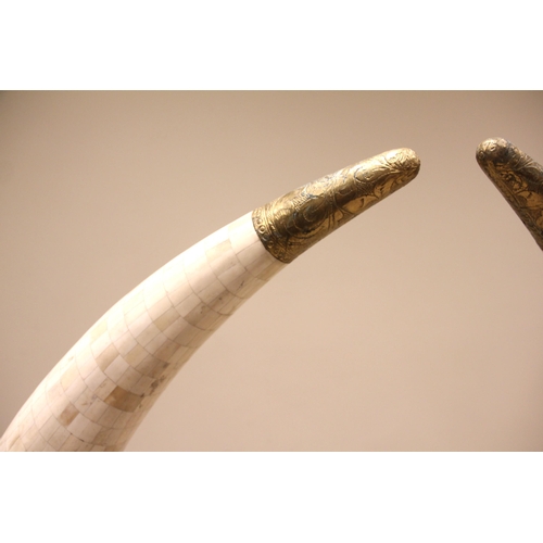 516 - A large pair of simulated elephant tusks, Indian, mid 20th century, each applied with camel bone til... 